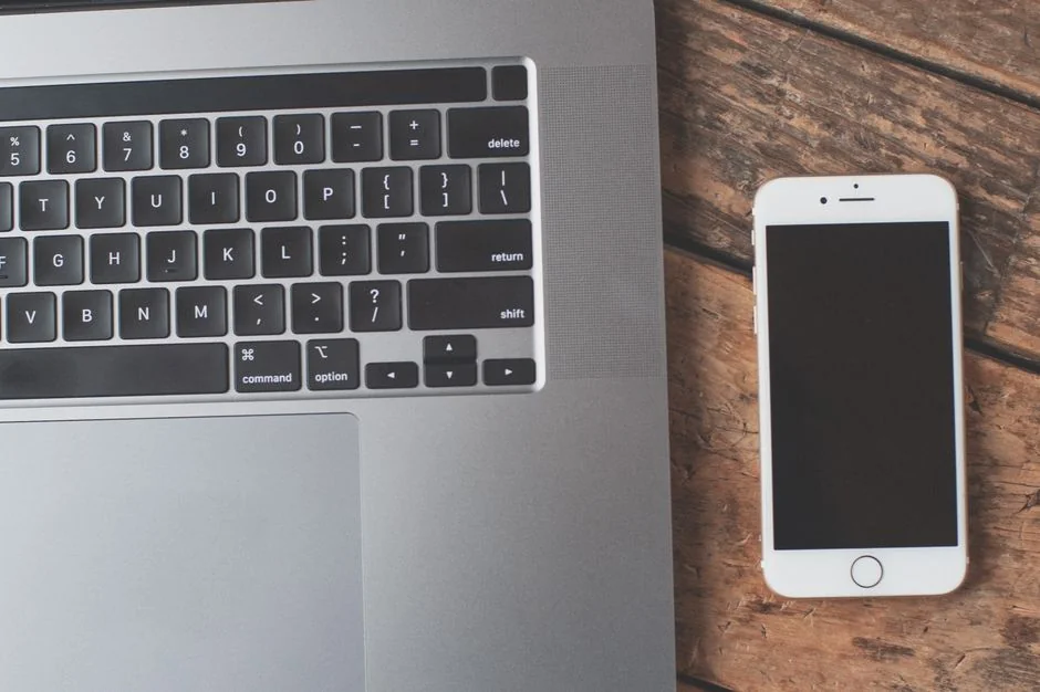 A modern workspace featuring a laptop, a tablet, and smartphones, well suited to tech and freelance work.